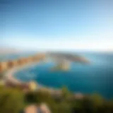 Panoramic view of Shat' Al Hamriya's coastline showcasing urban development